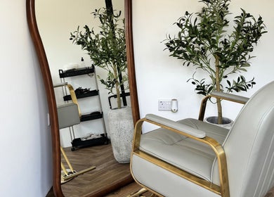 Elegant chair beside a mirror at The Hair Studio Extensions, Maidenhead, England, GB.