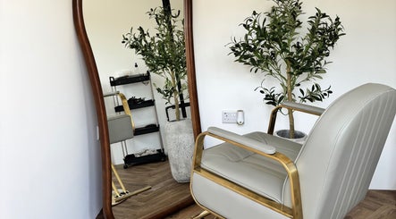 Elegant chair beside a mirror at The Hair Studio Extensions, Maidenhead, England, GB.