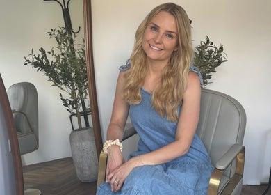 Smiling woman with long hair at The Hair Studio Extensions, Maidenhead, England, GB, exuding warmth and style.