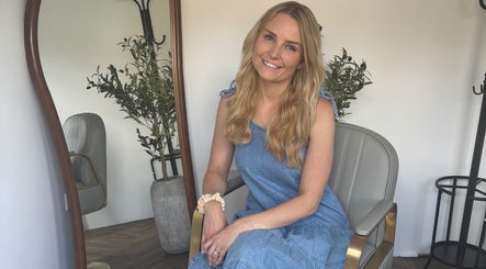 Smiling woman with long hair at The Hair Studio Extensions, Maidenhead, England, GB, exuding warmth and style.