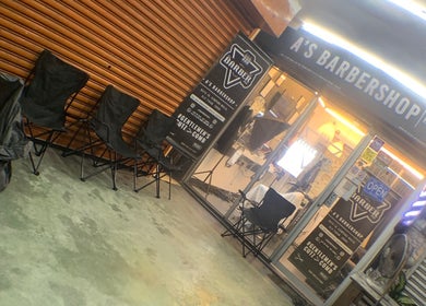 A'S BARBERSHOP entrance in Ulu Tiram, Johor Darul Ta'zim, MY, showing chairs and signage.