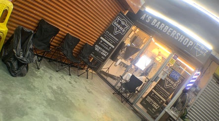 A'S BARBERSHOP entrance in Ulu Tiram, Johor Darul Ta'zim, MY, showing chairs and signage.