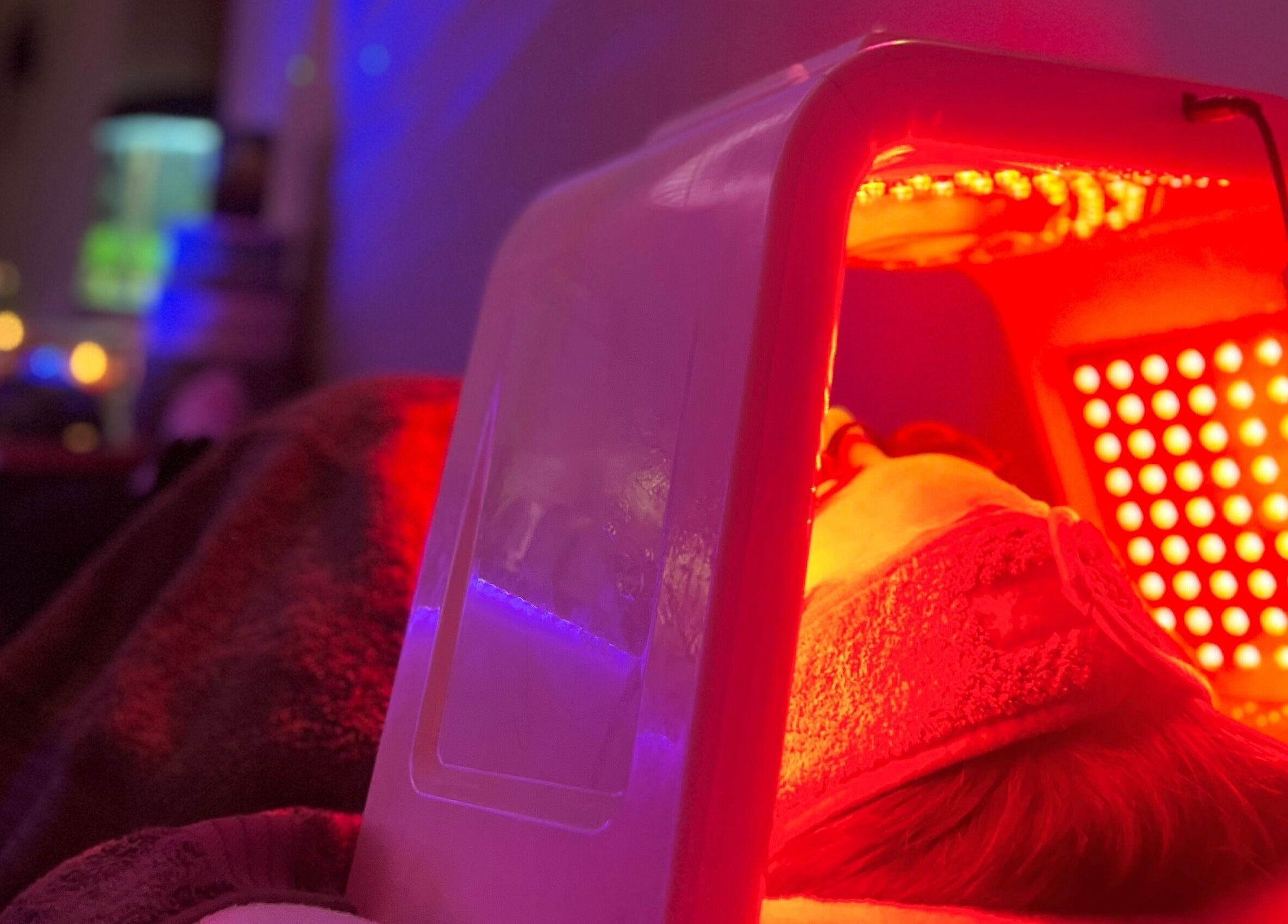 LED therapy session at The Glow House, Hutton Rudby, England, GB with soothing red light.