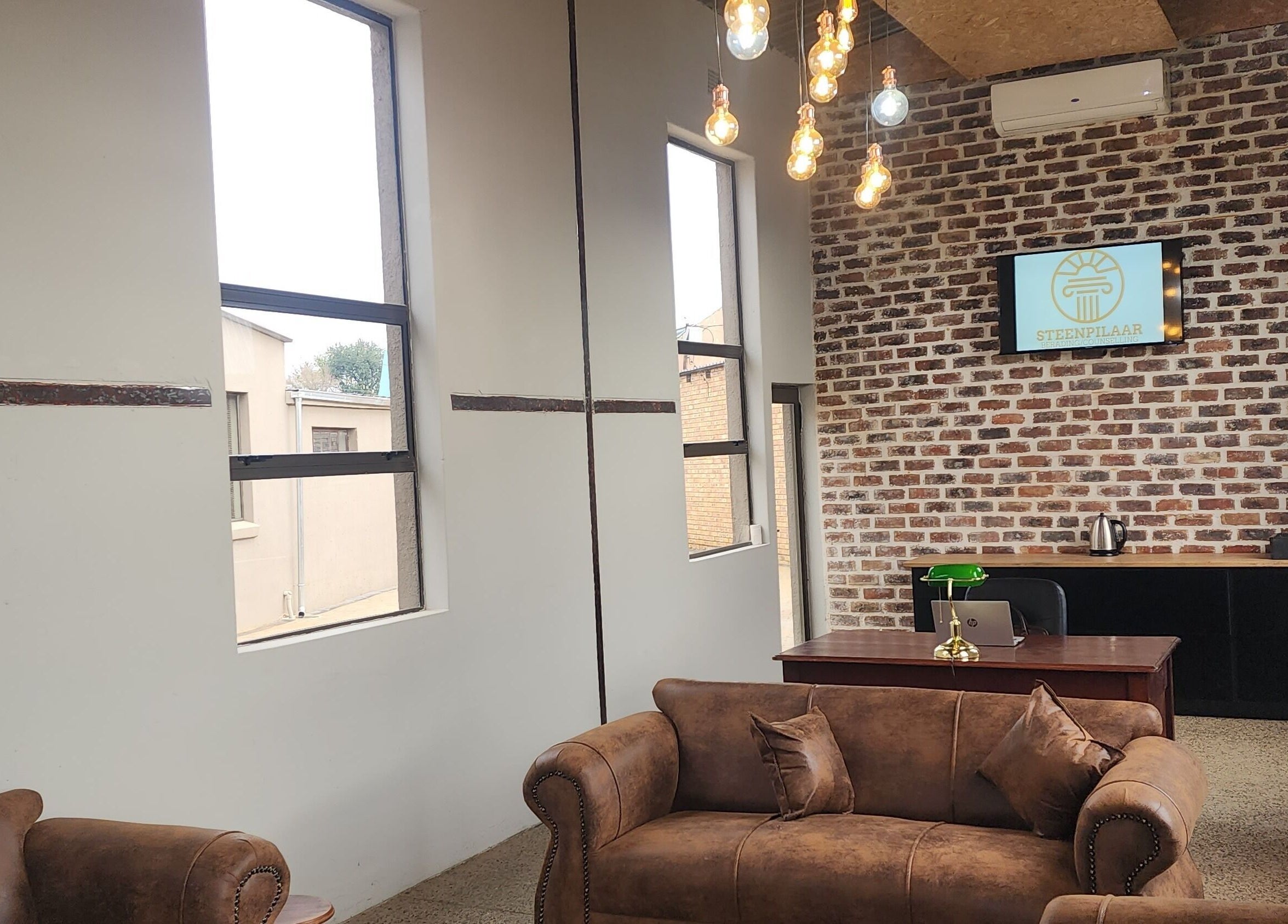 Cozy seating area with vintage couches at Steenpilaar, Nigel, Gauteng, ZA showcasing a modern rustic design.