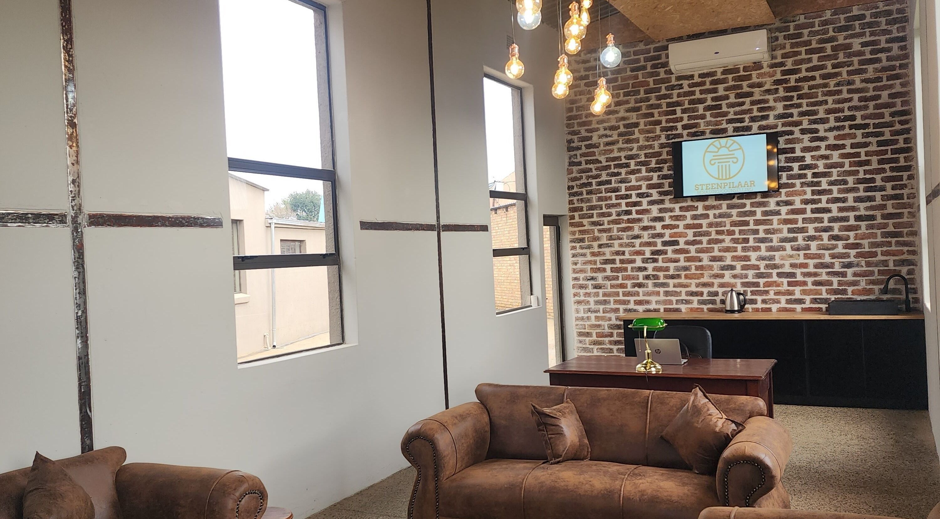 Cozy seating area with vintage couches at Steenpilaar, Nigel, Gauteng, ZA showcasing a modern rustic design.
