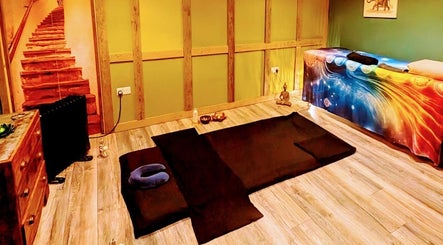 Tranquil massage room at Balance and Heal, Royston, England, GB with colorful decor and wooden accents.