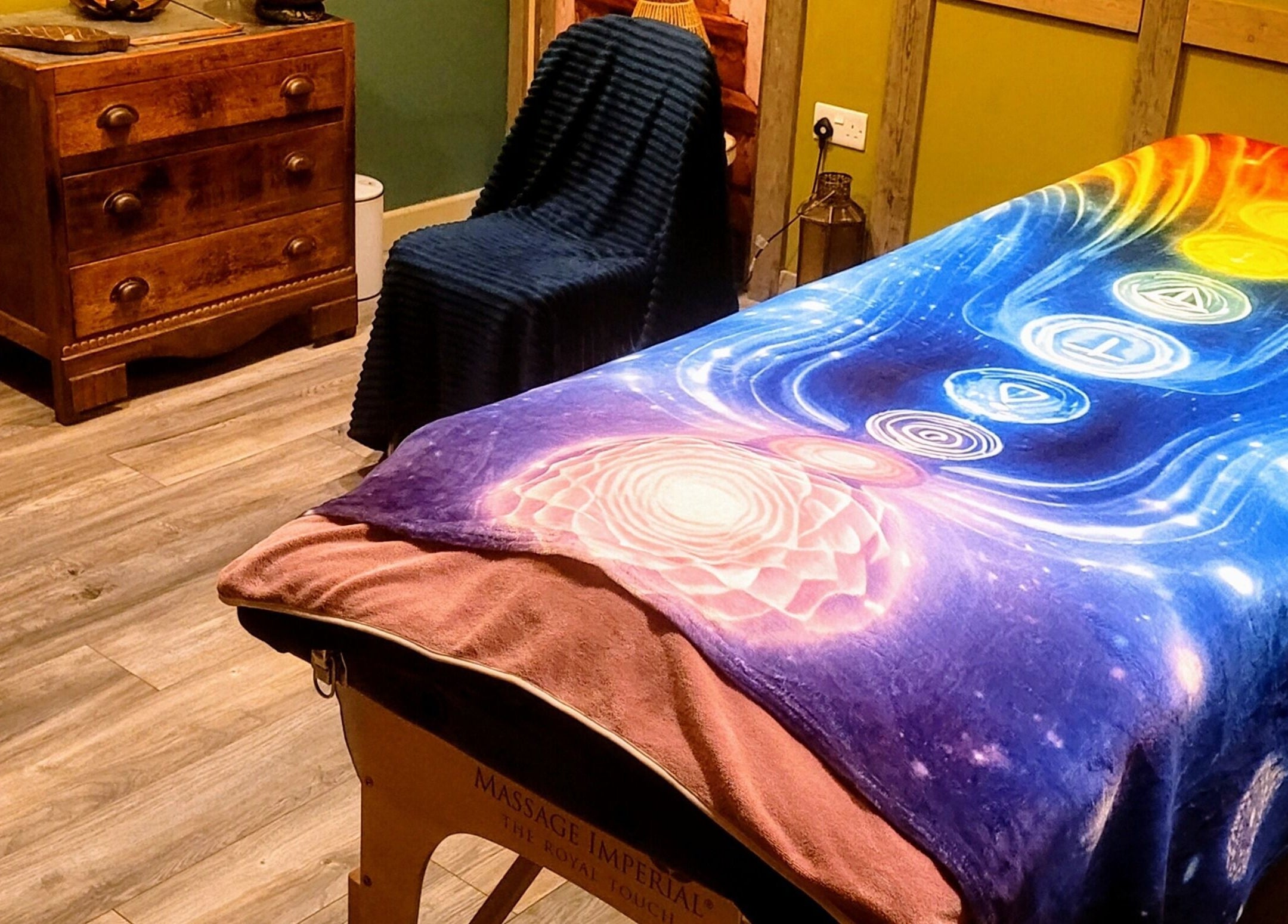 Serene massage room at Balance and Heal, Royston, England, GB, featuring colorful chakra blanket.