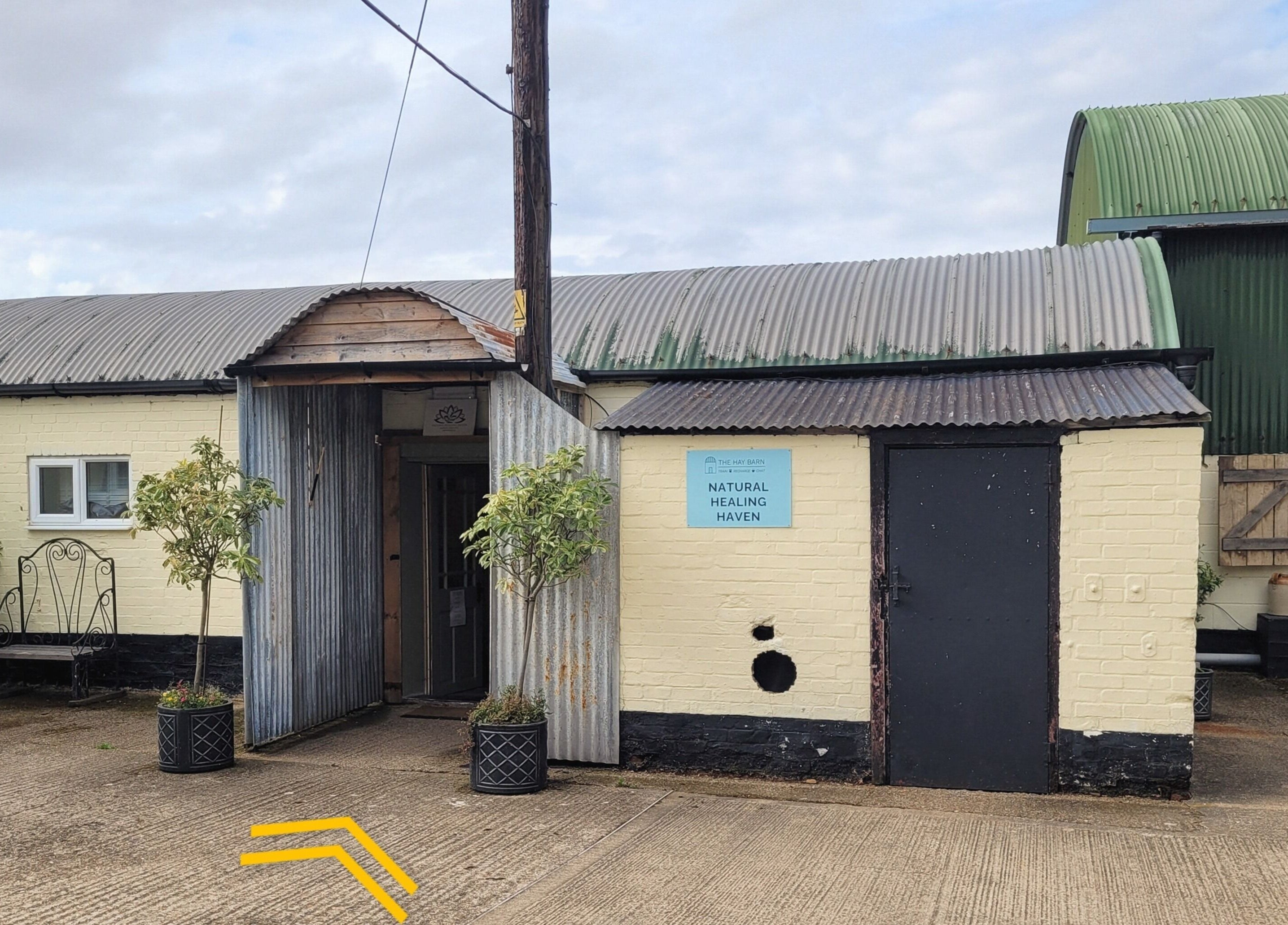 Exterior view of Balance and Heal, a serene venue in Royston, England, GB, with lush greenery.