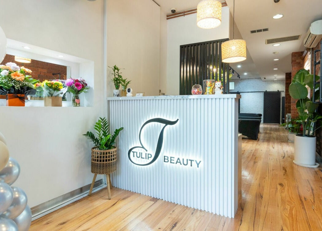 Reception area at Tulip Beauty Lash and Brow in Melbourne, Victoria, AU, featuring modern decor and floral accents.