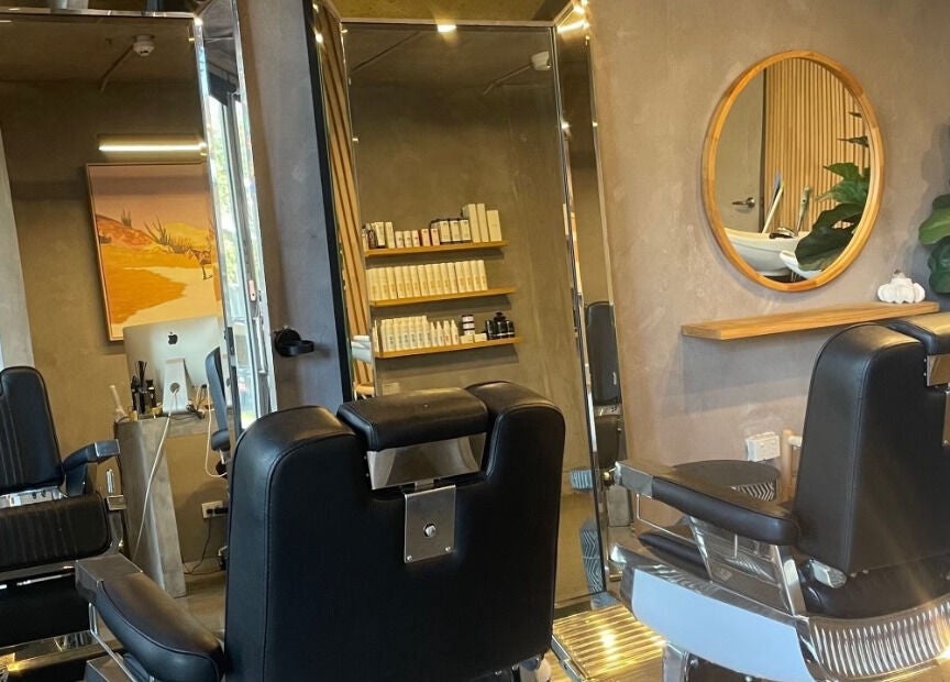 Modern salon chairs at Nikola Krstev Salon, Wollongong, New South Wales, AU with stylish decor and products.