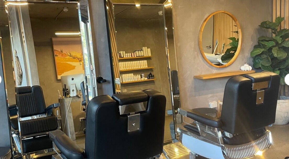 Modern salon chairs at Nikola Krstev Salon, Wollongong, New South Wales, AU with stylish decor and products.