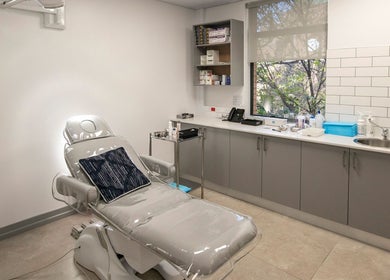 Lux Clinic treatment room in Johannesburg, Gauteng, ZA, featuring a modern aesthetic with a reclining chair.