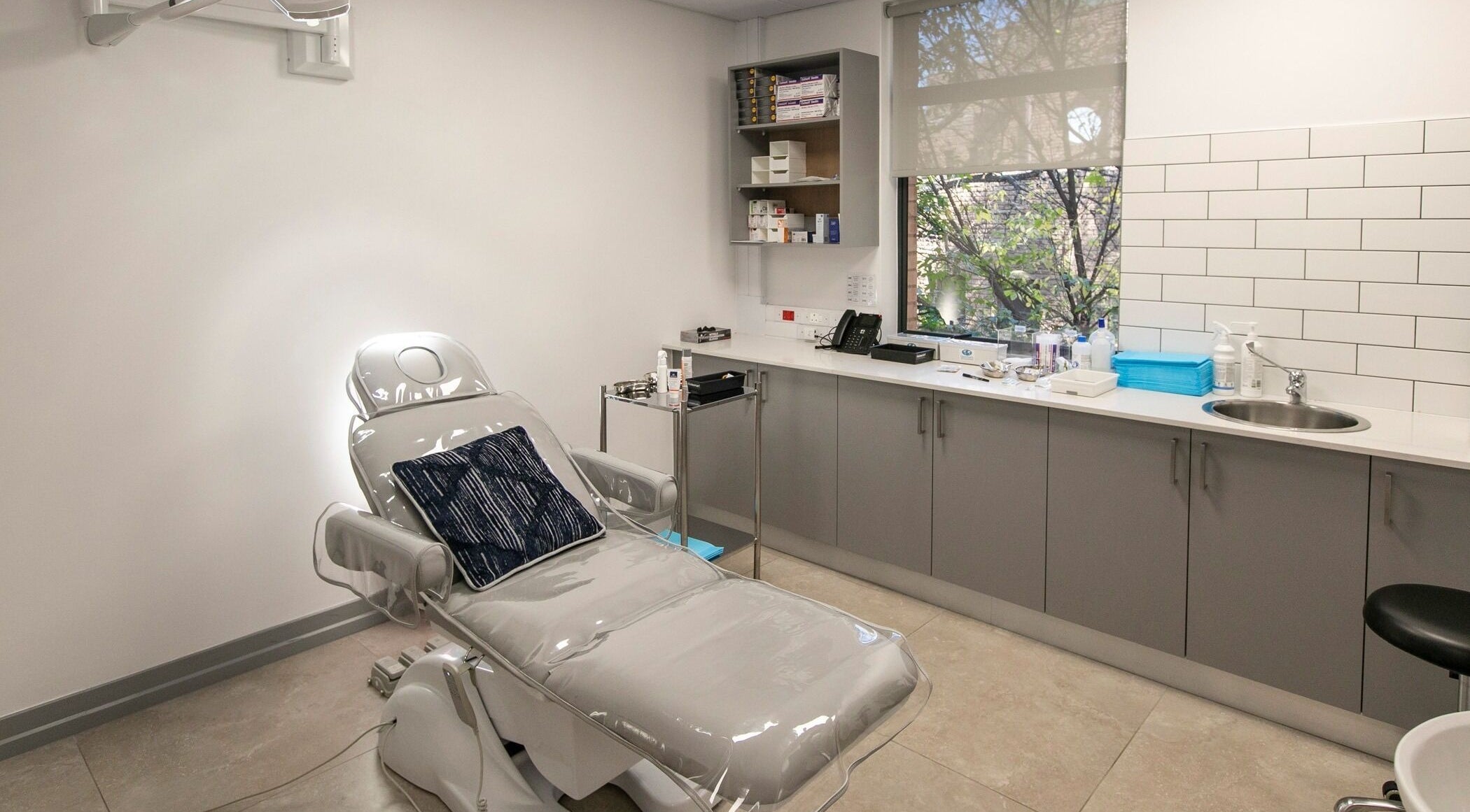 Lux Clinic treatment room in Johannesburg, Gauteng, ZA, featuring a modern aesthetic with a reclining chair.