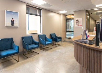 Lux Clinic waiting area with plush blue chairs in Johannesburg, Gauteng, ZA, exuding sophistication.