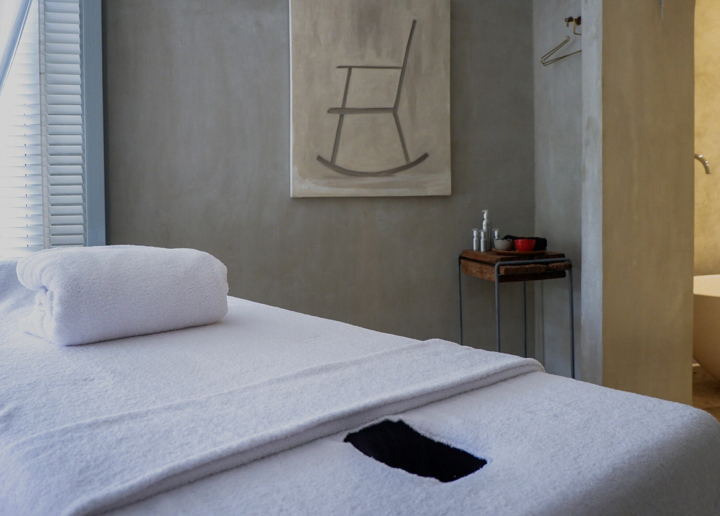 Relaxing massage room at Terra Spa & Wellness in Bali, Bali, ID featuring a cozy massage table and serene decor.