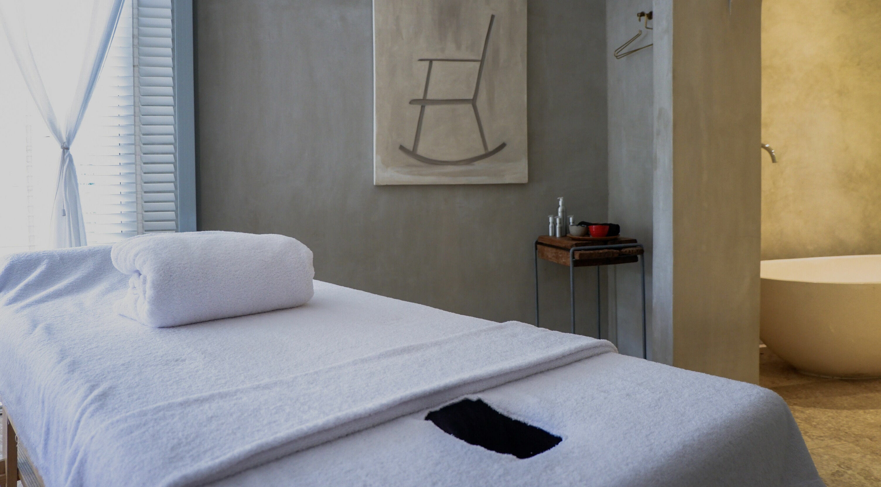 Relaxing massage room at Terra Spa & Wellness in Bali, Bali, ID featuring a cozy massage table and serene decor.