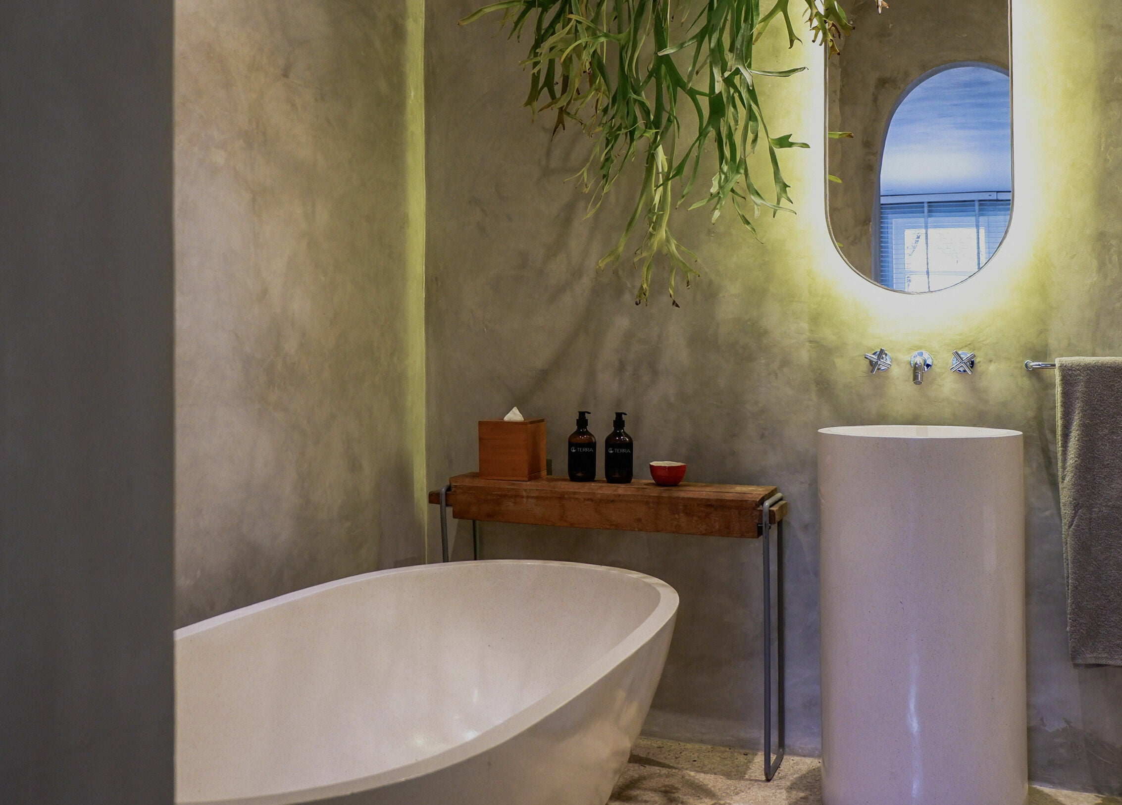 Luxurious minimalist bathroom at Terra Spa & Wellness, Bali, ID, featuring a serene tub and ambient lighting.