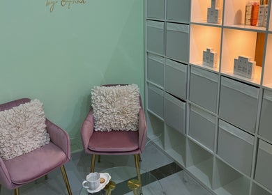 Chic seating area at Facial Boutique by Anna, Doha, Doha Municipality, QA with plush chairs and elegant shelving.