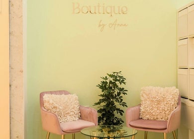 Elegant seating area at Facial Boutique by Anna, Doha, Doha Municipality, QA featuring pink chairs and greenery.