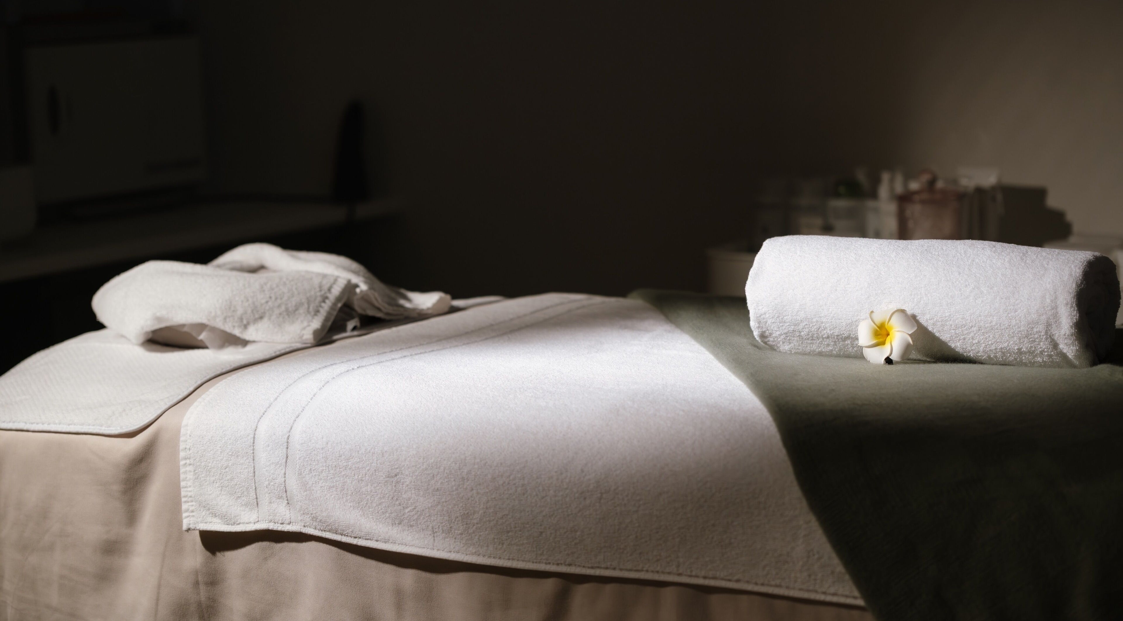 Relaxing massage bed setup at Facial Boutique by Anna, Doha, Doha Municipality, QA, with lush green accents.