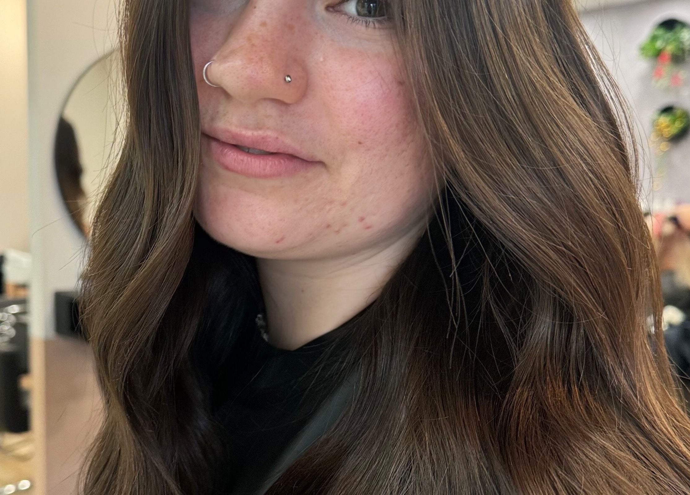 Woman with wavy hair styled at Avenlee Hair Artistry in Currambine, Western Australia, AU, salon ambience.