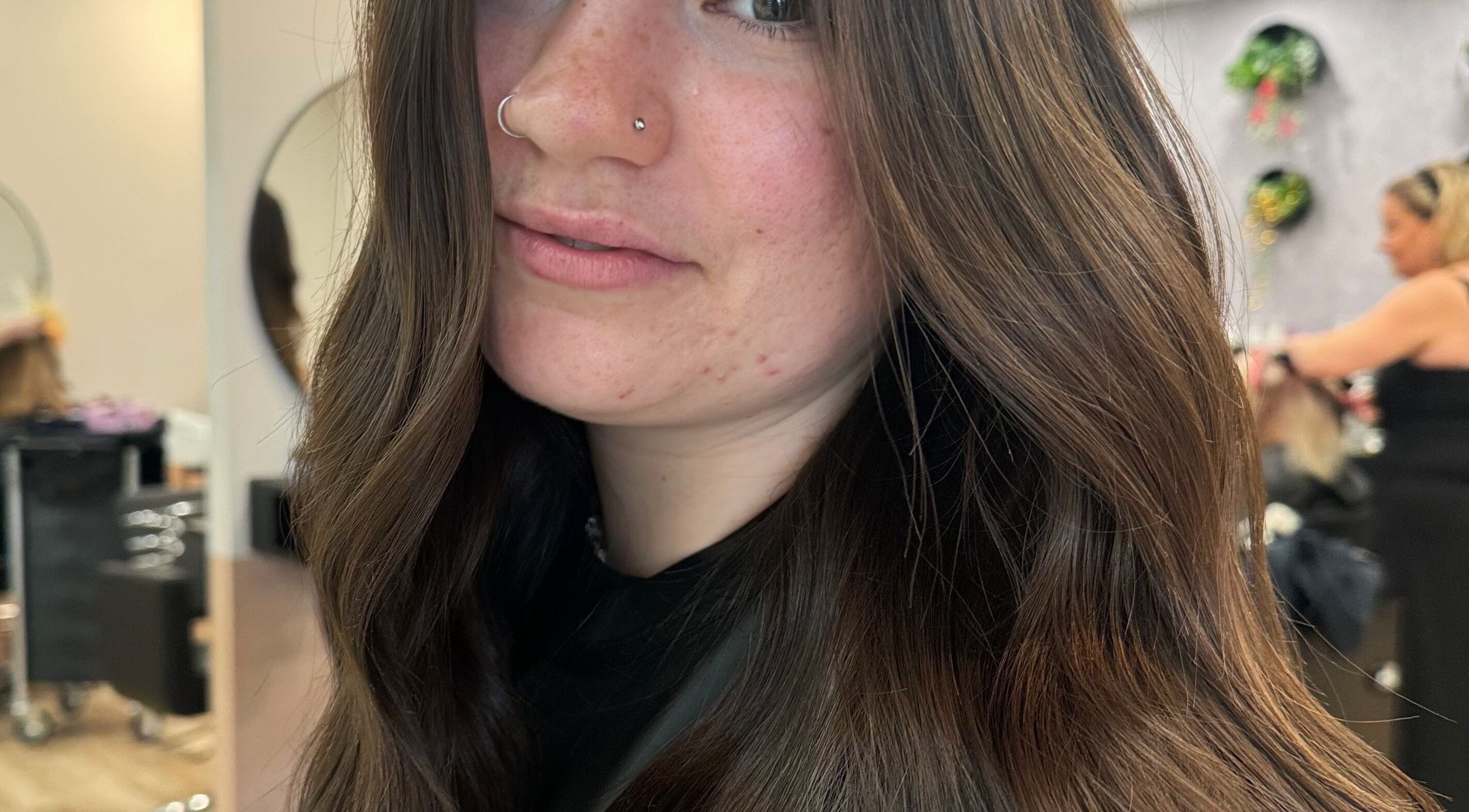 Woman with wavy hair styled at Avenlee Hair Artistry in Currambine, Western Australia, AU, salon ambience.