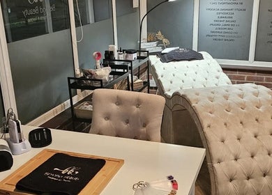 Elegant treatment room at Skin By Shukri in Sheffield, England, GB, featuring plush chairs and modern decor.