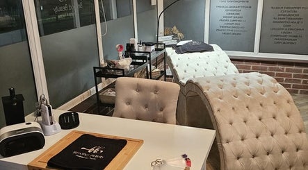 Elegant treatment room at Skin By Shukri in Sheffield, England, GB, featuring plush chairs and modern decor.