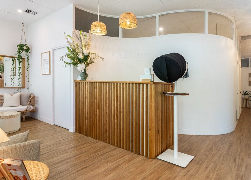 Elegant reception at Fresh Face Skin, Melbourne, Victoria, AU, featuring wooden decor and warm lighting.