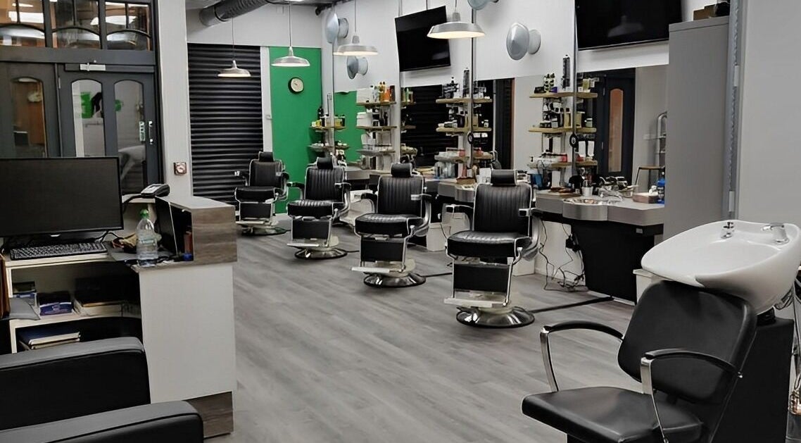 Spacious interior of No'1 Barbers, No'1 Hair Clinic in Newport, Wales, GB with elegant seating and modern decor.