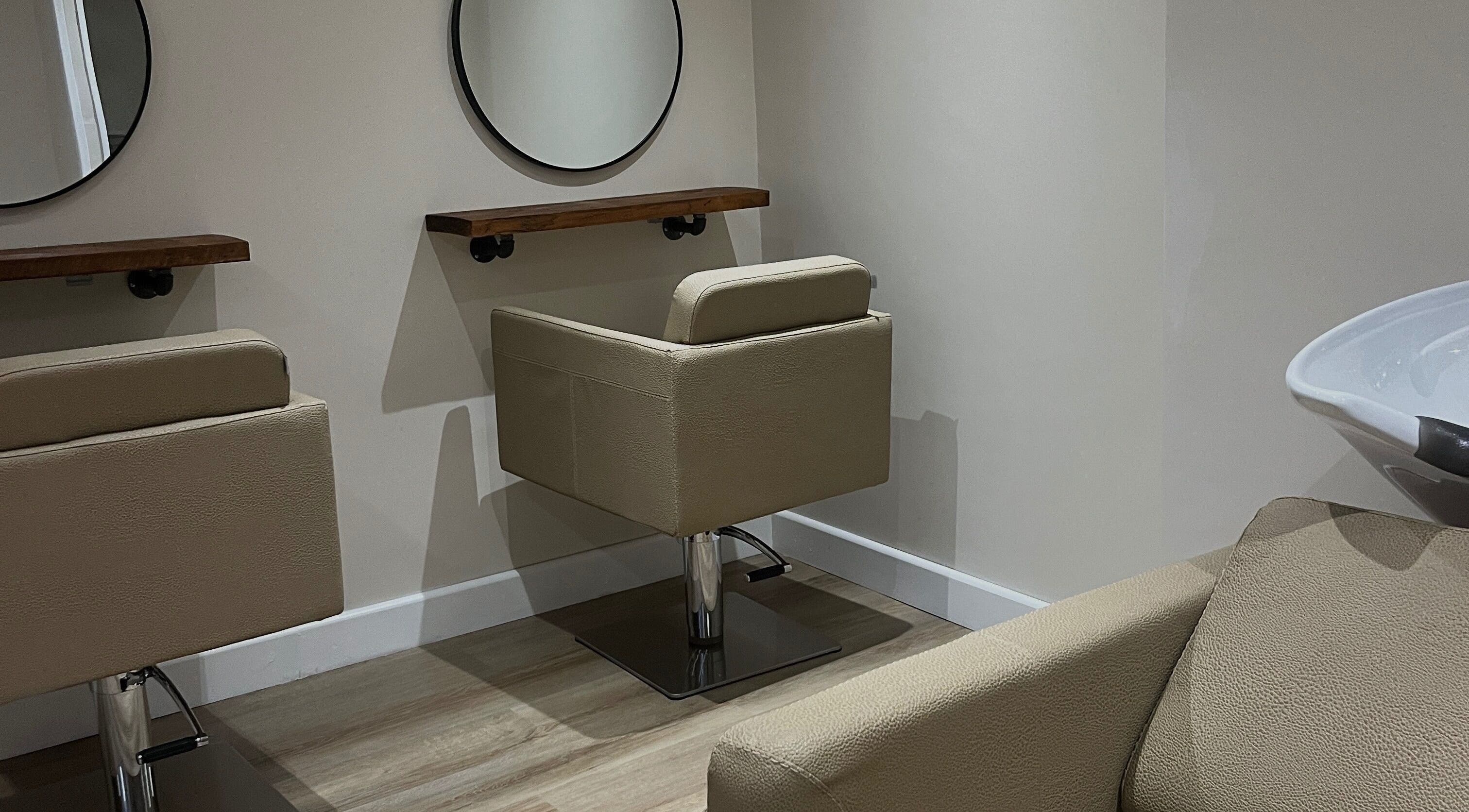Elegant salon seating area at Novae, Huddersfield, England, GB with beige chairs and mirrors.