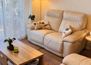 Relaxing seating area at Good Times & Tan Lines, Runaway Bay, Queensland, AU with plush sofas and ambient lighting.