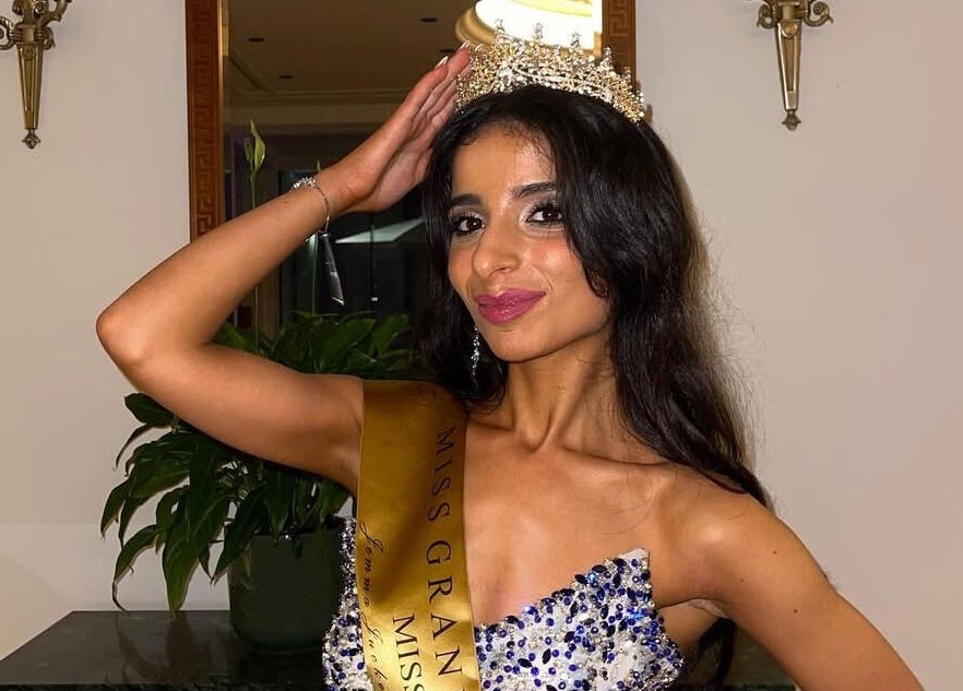 A woman in a jeweled gown with a crown at Good Times & Tan Lines, Runaway Bay, Queensland, AU.