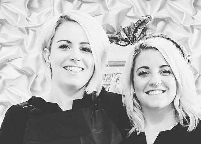 Friendly team at IrreSiStible Hair & Beauty, Exeter, England, GB, smiling in front of elegant background.