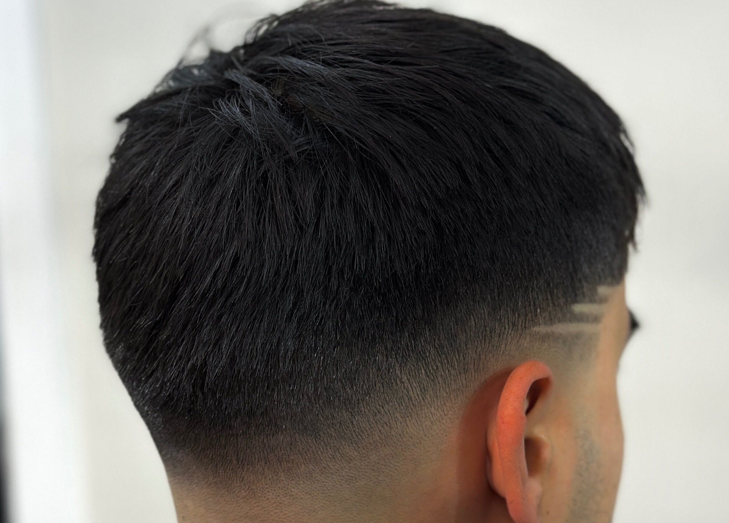 Close-up of a precise fade haircut at Charro Barber, Montebello, California, US, showcasing expert styling.
