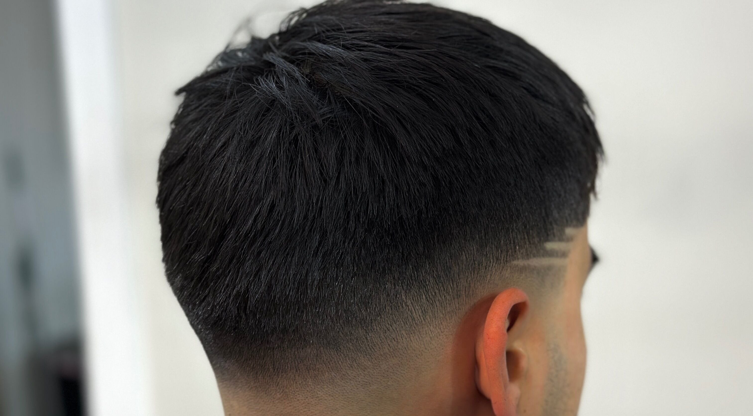 Close-up of a precise fade haircut at Charro Barber, Montebello, California, US, showcasing expert styling.