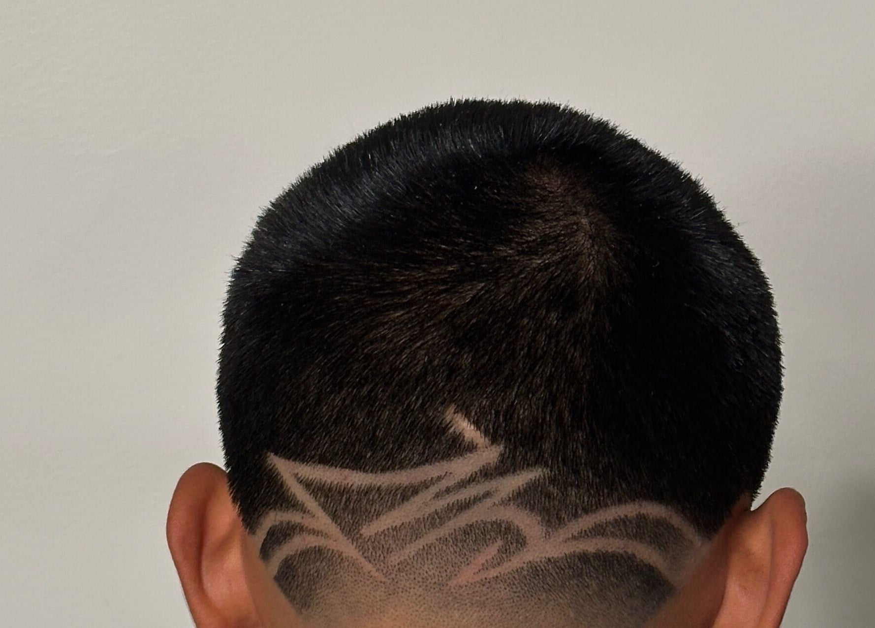 Intricate hair design on a man's head at Charro Barber in Montebello, California, US.