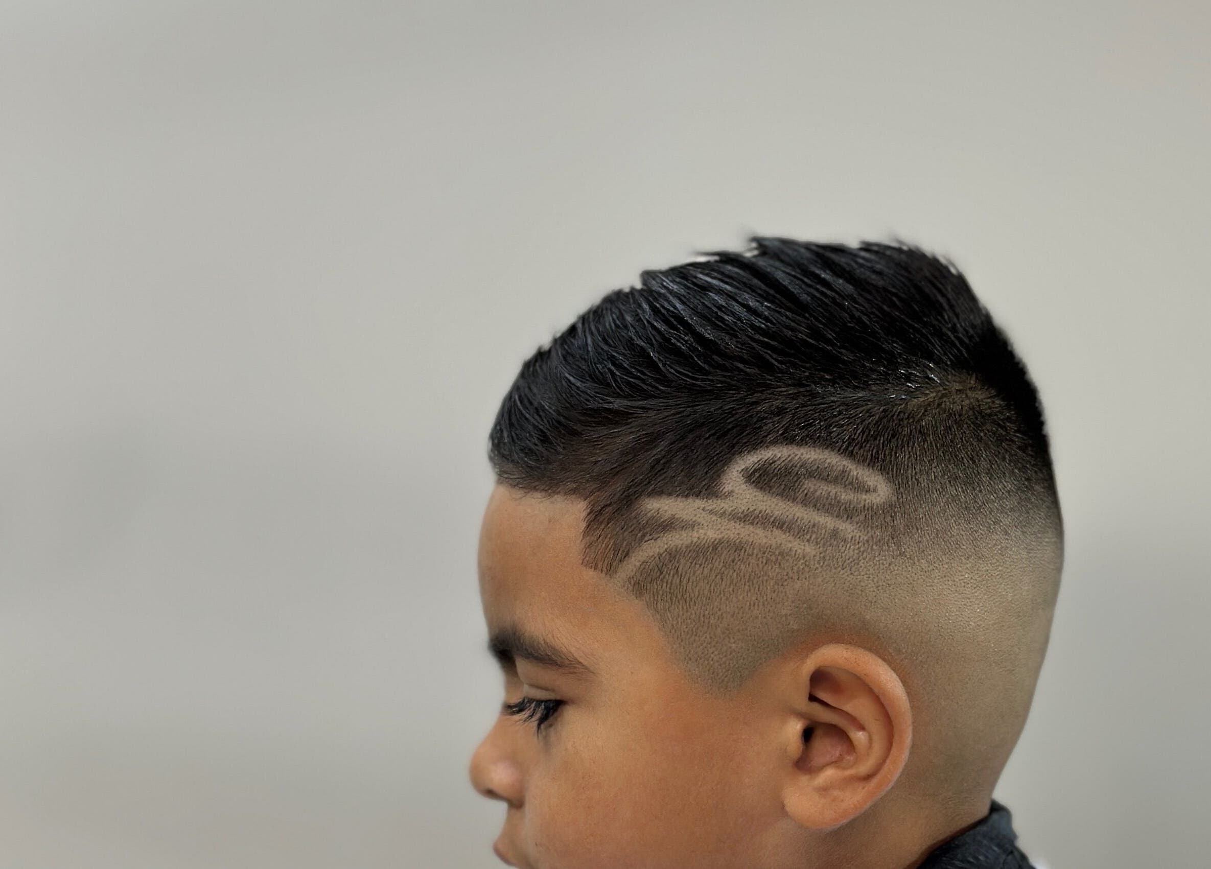 Creative hair design and fade cut for a child at Charro Barber, Montebello, California, US.