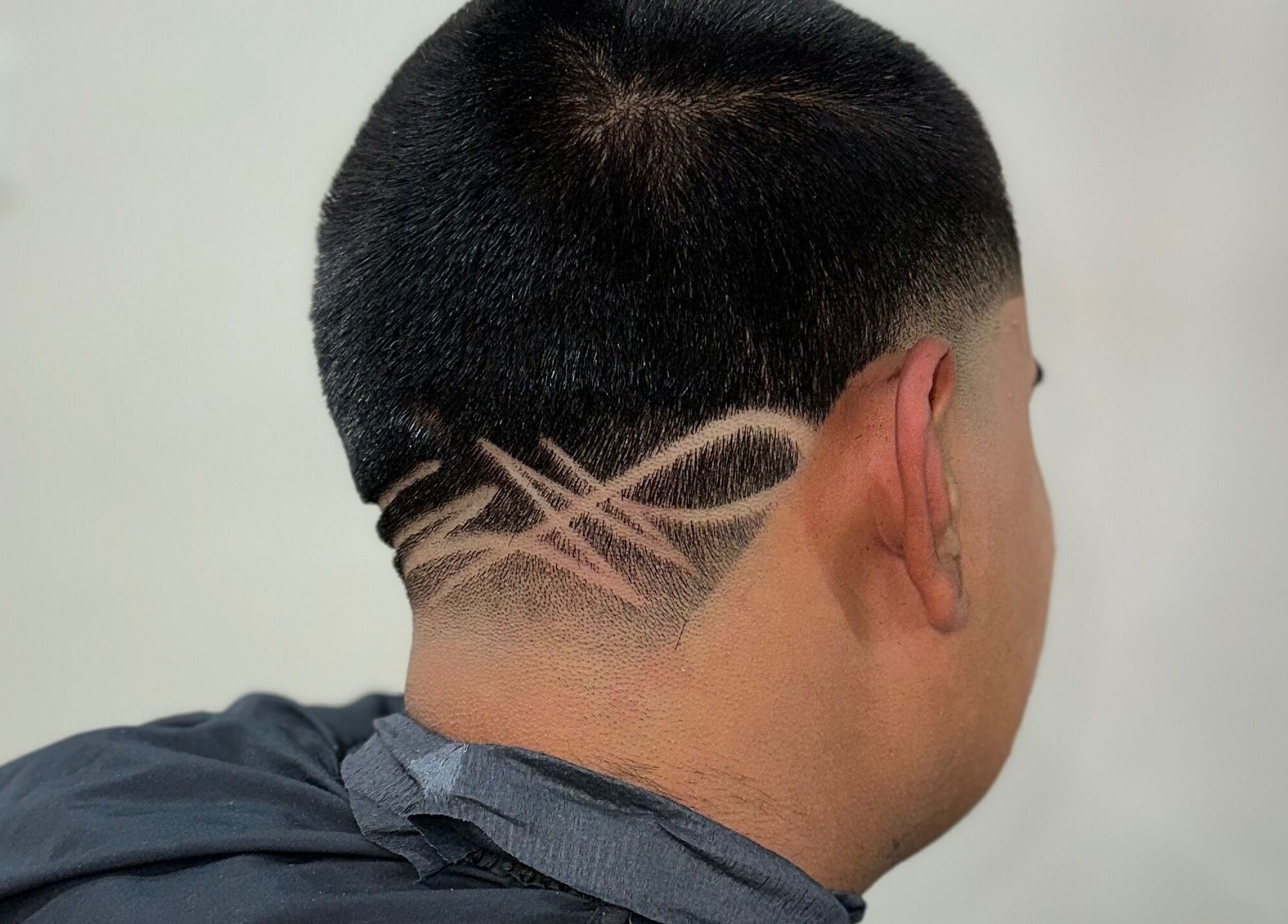 Stylish hair design at Charro Barber, Montebello, California, US, showcasing intricate clipper art.