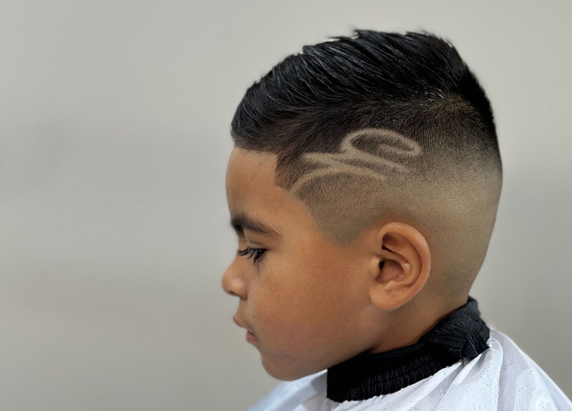 Boy with stylish fade design at Charro Barber in Montebello, California, US.
