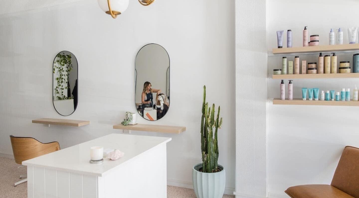 Stellar Salon's modern interior with mirrors, chic seating, and shelves of products in Coolangatta, Queensland, AU.