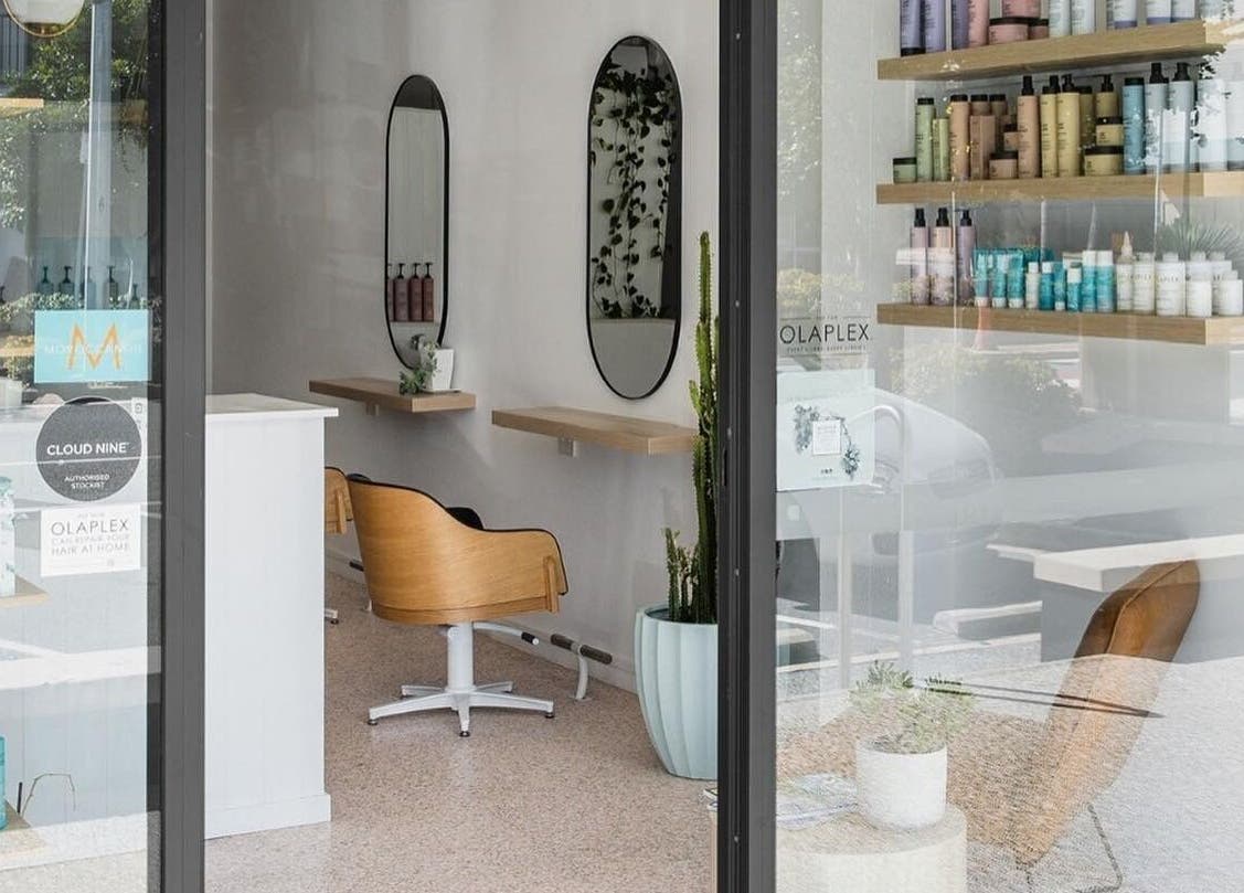 Elegant interior of Stellar Salon, Coolangatta, Queensland, AU, showcasing chic seating and premium hair products.