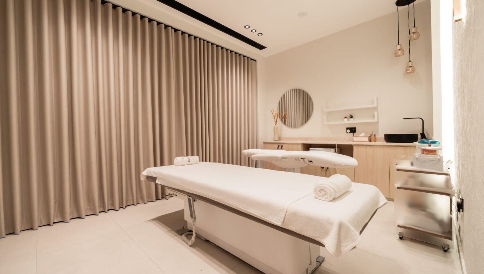 Serene spa room at Huracan By Amel - Ladies in Dubai, Dubai, AE with massage table and calming decor.