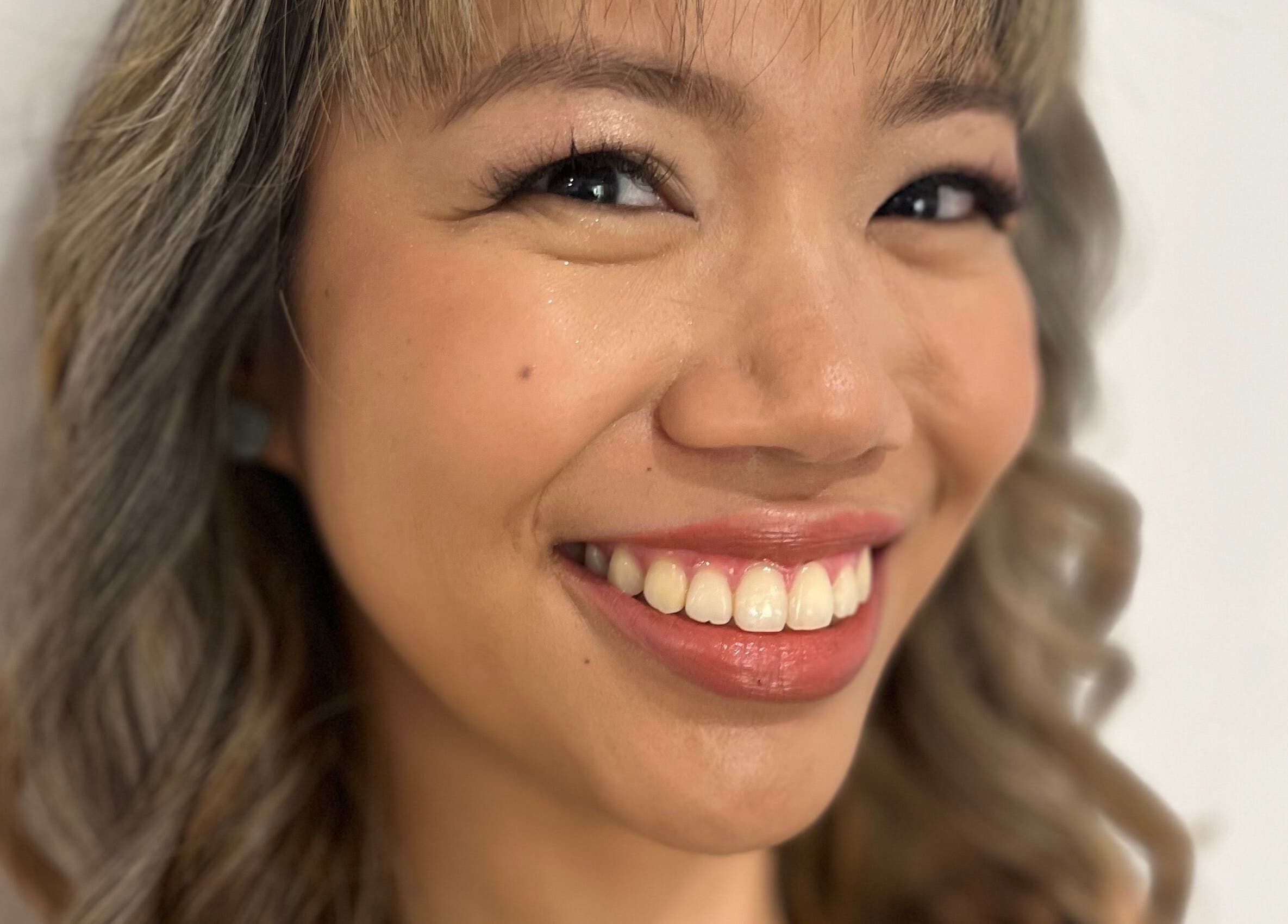 Client smiling with styled hair at Jamie Elle Hair Makeup Extensions in Southport, Queensland, AU.