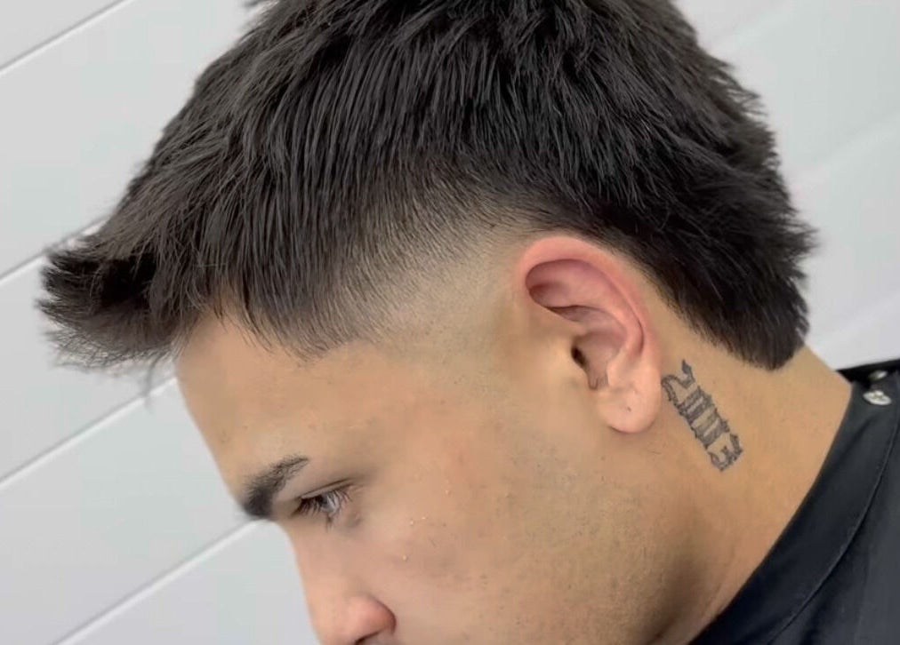 Modern hairstyle at Matteo Cau, Croydon, South Australia, AU, showcasing a sharp fade and neat styling.