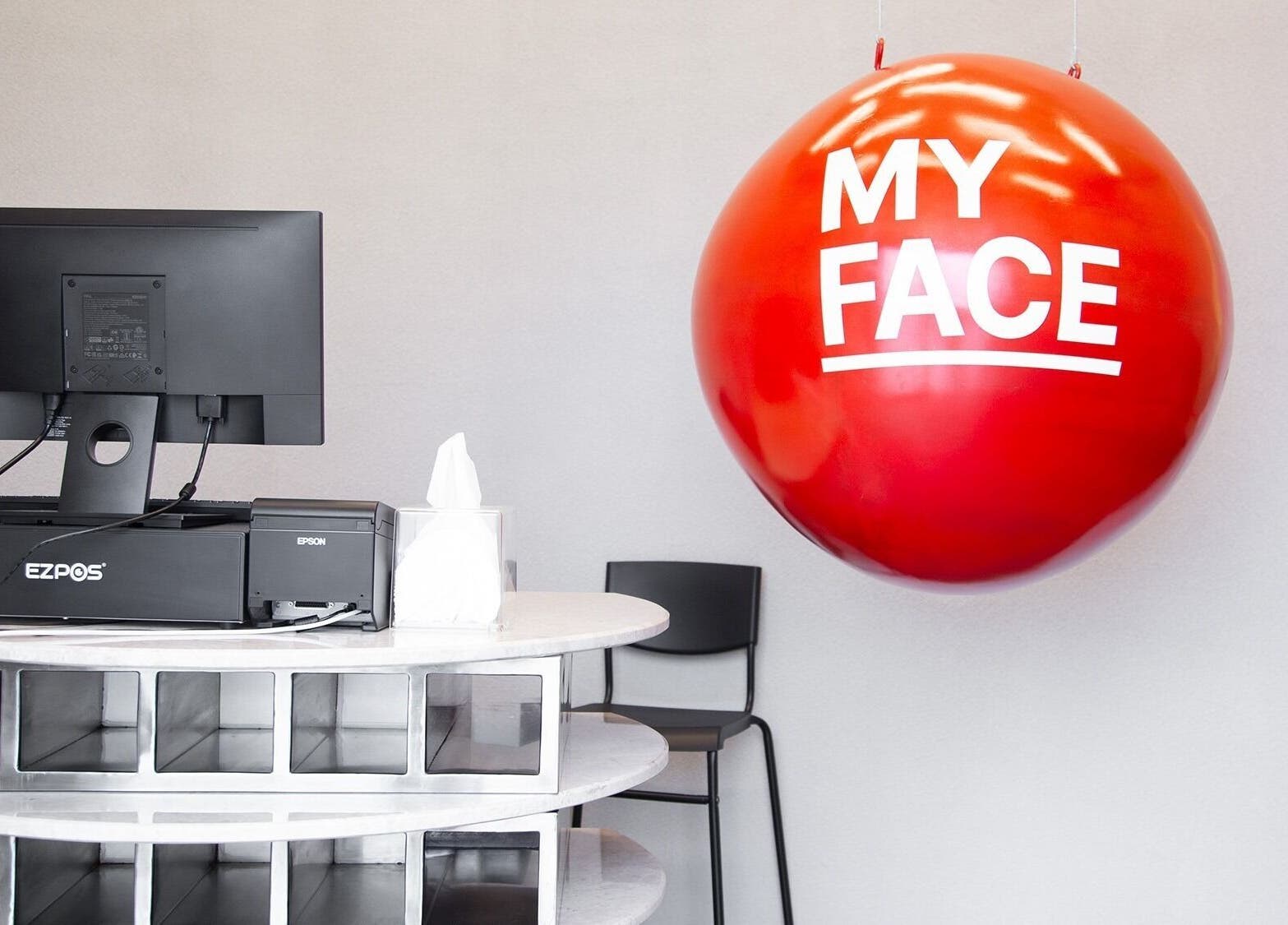 Reception area at My Face in Riyadh, Riyadh Province, SA with red decor and computer setup.