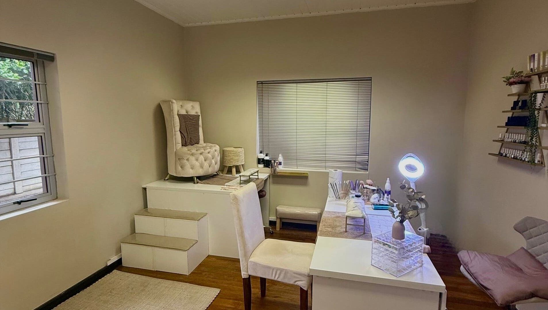 Elegant spa room at Aura Beauty & Wellness, Windhoek, Khomas Region, NA, featuring plush seating and decor.