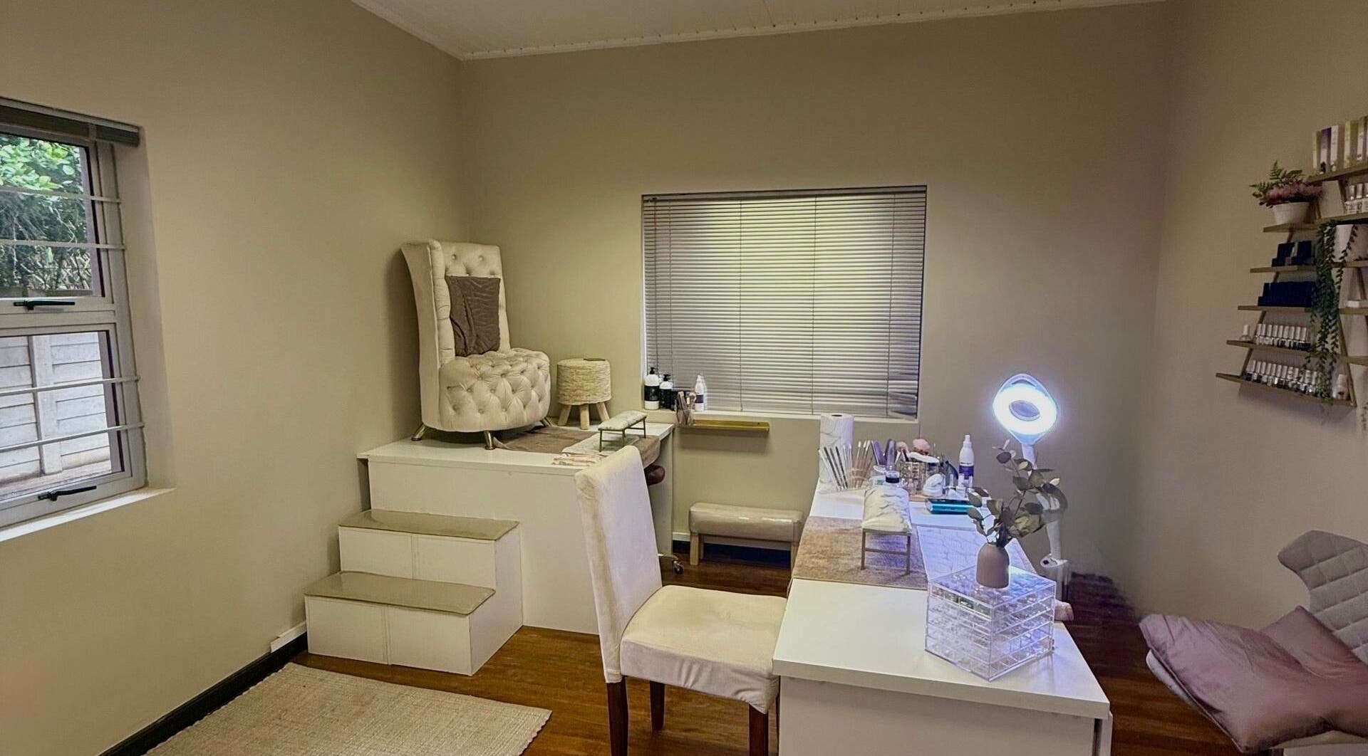 Elegant spa room at Aura Beauty & Wellness, Windhoek, Khomas Region, NA, featuring plush seating and decor.