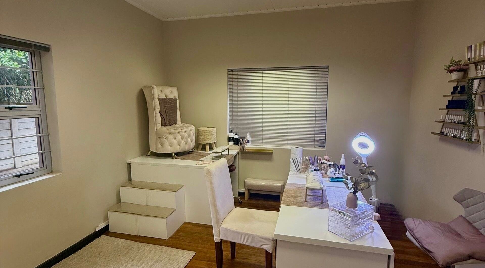 Elegant spa room at Aura Beauty & Wellness, Windhoek, Khomas Region, NA, featuring plush seating and decor.