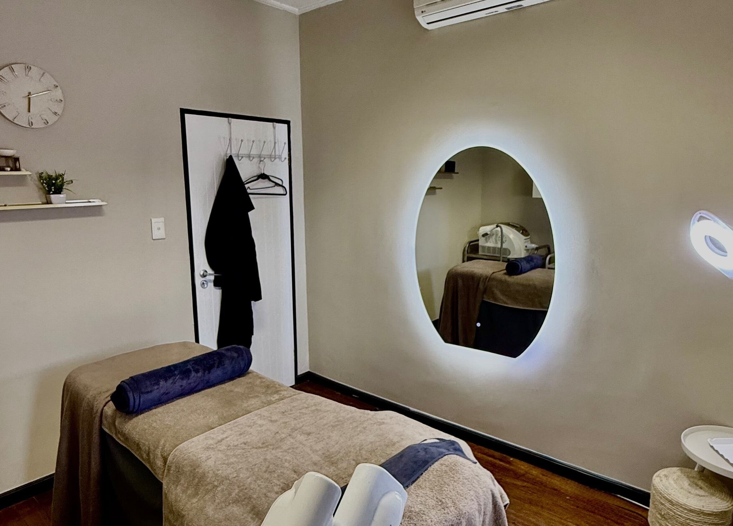 Calming treatment room at Aura Beauty & Wellness, Windhoek, Khomas Region, NA, with soothing decor and lighting.